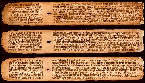 A few palm leaves from the Buddhist Sanskrit text Shisyalekha composed in the 5th century by Candragomin. Shisyalekha was written in Devanāgarī script by a Nepalese scribe in 1084&nbsp;CE. The manuscript is in the Cambridge University library.