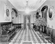 Entrance hall of Davies House with black walnut trim and carved plaster