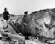 CY Cook (left) and LCDR Knapper of USS&nbsp;Texas&nbsp;(BB-35) inspecting bombardment damage, Pointe du Hoc, France, 1944.