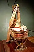 King of Rome's Cradle; by Pierre-Paul Prud'hon, Henri Victor Roguier, Jean-Baptiste-Claude Odiot and Pierre-Philippe Thomire; 1811; wood, silver gilt, mother-of-pearl, sheets of copper covered with velvet, silk and tulle, decorated with silver and gold thread; height: 216&nbsp;cm; Kunsthistorisches Museum, Vienna, Austria