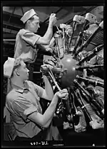 Aviation machinists mates working on a aircraft engine