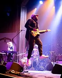Strange playing guitar and jumping