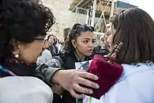 A woman pushing back against other women