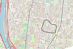 Map showing modern street layout using Open Street Map graphics, overlaid with an outline of the old racetrack.