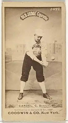 Standing man in baseball uniform catching a ball