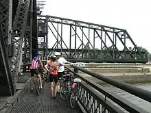 Cyclists on the bridge, waiting for it to close