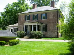 a boxy brick house with a hipped roof