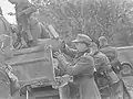 German soldiers loading a vehicle during the surrender.