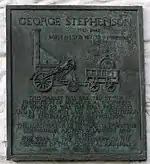 Colour photograph of a bronze memorial tablet