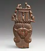Head of Hathor from a clapper; 1295–664&nbsp;BC; possibly boxwood; 12 × 6.2&nbsp;cm; Metropolitan Museum of Art