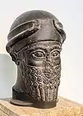 Assyrian head of a bearded god wearing a cap with horns dedicated by Puzur-Eshtar of Mari; middle Bronze Age; height: 37&nbsp;cm (15&nbsp;in); Vorderasiatisches Museum (Berlin, Germany)