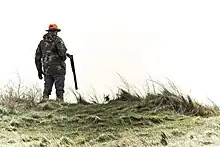 Hunter with long-barreled shotgun