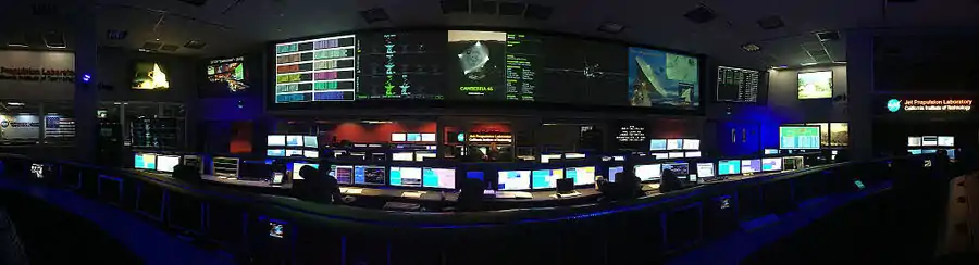 panaorama of the SFOF from the center of the room between the Cassini and Curiosity mission control consoles