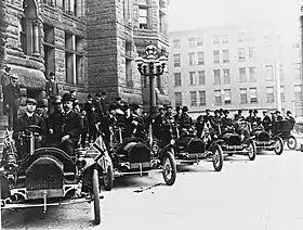 A row of Russell motor cars in front of Toronto city hall in 1909.  Tommy Russell is seated in the driver's seat of the first car.