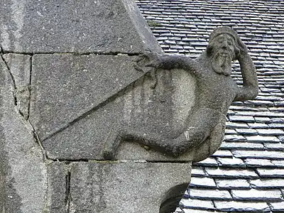 Unusual carving on church exterior at Loqueffret