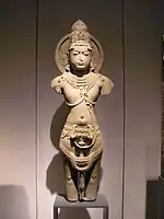 Yellow sandstone sculpture of a standing deity, 11th century CE, Rajasthan.