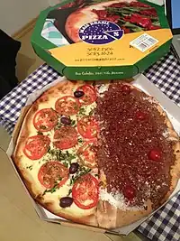 An unusual order of half savory (tomatoes, olives), half sweet (Prestígio&nbsp;[pt]: chocolate with coconut) pizza