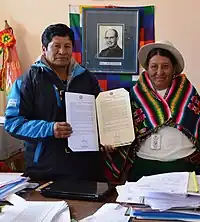 Plácida Espinoza next to a school administrator.