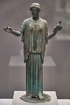 Wearing a peplos over a  chiton, a later style