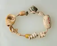 String of beads; 4400–3800&nbsp;BC; the beads are made of bone, serpentinite and shell; length: 15&nbsp;cm; Metropolitan Museum of Art