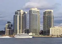 Two Northside Piers, a high-rise clad in gray-blue glass, viewed in the center from the East River