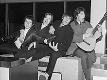 The four Kinks pose and play for the photographer