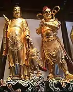 Jade Buddha Temple (Shanghai, China) - Statues of Hārītī (Guǐzǐmǔ) on the left and Pañcika (Sànzhī Dàjiàng) on the right.