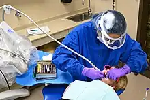 A U.S. Air Force dental technician from the 28th Medical Group cleans a child's teeth at Ellsworth Air Force Base, South Dakota, March 2023.