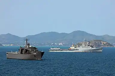 RSS Resolution at anchor in the Gulf of Thailand, with USS&nbsp;Denver passing behind during Cobra Gold '11.