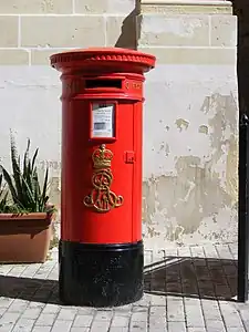 A red pillar box in Vittoriosa, Malta. In the 1980s, royal cyphers were ground off the pillar boxes in Valletta and Floriana, but most others remained intact.